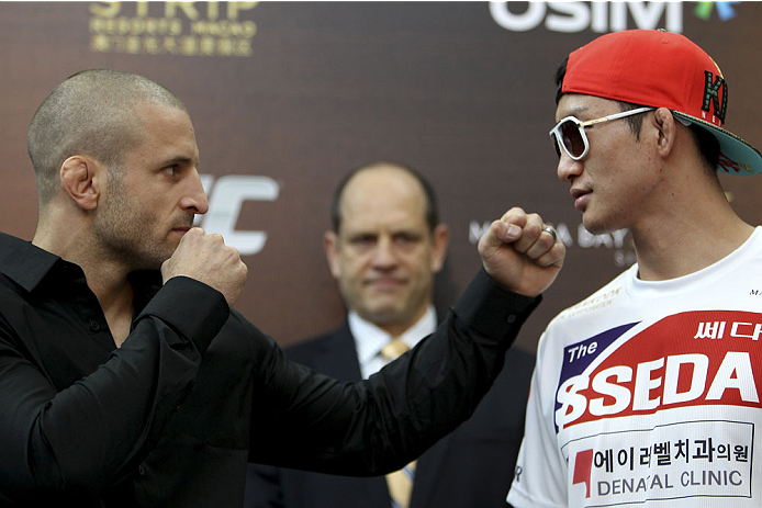 SINGAPORE - JANUARY 02: (L-R) Opponents Tarec Saffiedine and Gyu Lim Hyun face off during the UFC Fight Night Singapore Ultimate Media Day at the Shoppes at Marina Bay Sands on January 2, 2014 in Singapore. (Photo by Mitch Viquez/Zuffa LLC/Zuffa LLC via