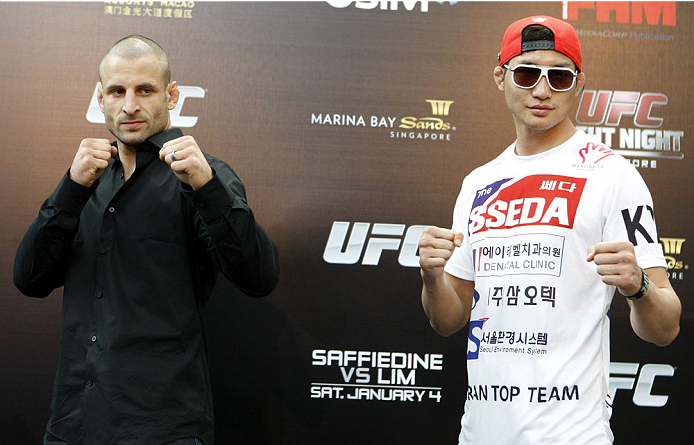 SINGAPORE - JANUARY 02: (L-R) Opponents Tarec Saffiedine and Gyu Lim Hyun pose for photos during the UFC Fight Night Singapore Ultimate Media Day at the Shoppes at Marina Bay Sands on January 2, 2014 in Singapore. (Photo by Mitch Viquez/Zuffa LLC/Zuffa L