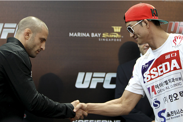 SINGAPORE - JANUARY 02: (L-R) Opponents Tarec Saffiedine and Gyu Lim Hyun shake hands during the UFC Fight Night Singapore Ultimate Media Day at the Shoppes at Marina Bay Sands on January 2, 2014 in Singapore. (Photo by Mitch Viquez/Zuffa LLC/Zuffa LLC v