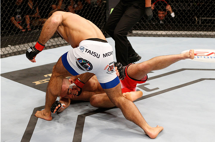 STOCKHOLM, SWEDEN - OCTOBER 04: Mairbek Taisumov (white trunks) of Russia punches Marcin Bandel of Poland in their lightweight bout at the Ericsson Globe Arena on October 4, 2014 in Stockholm, Sweden. (Photo by Josh Hedges/Zuffa LLC/Zuffa LLC)