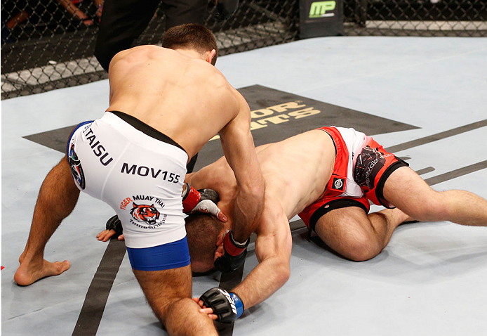 STOCKHOLM, SWEDEN - OCTOBER 04: Mairbek Taisumov (white trunks) of Russia punches Marcin Bandel of Poland in their lightweight bout at the Ericsson Globe Arena on October 4, 2014 in Stockholm, Sweden. (Photo by Josh Hedges/Zuffa LLC/Zuffa LLC)