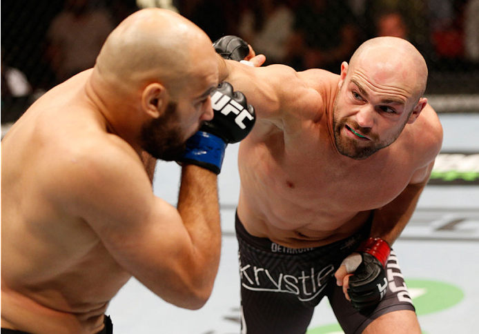 STOCKHOLM, SWEDEN - OCTOBER 04: (R-L) Cathal Pendred of Ireland punches Gasan Umalatov of Russia in their welterweight bout at the Ericsson Globe Arena on October 4, 2014 in Stockholm, Sweden. (Photo by Josh Hedges/Zuffa LLC/Zuffa LLC)