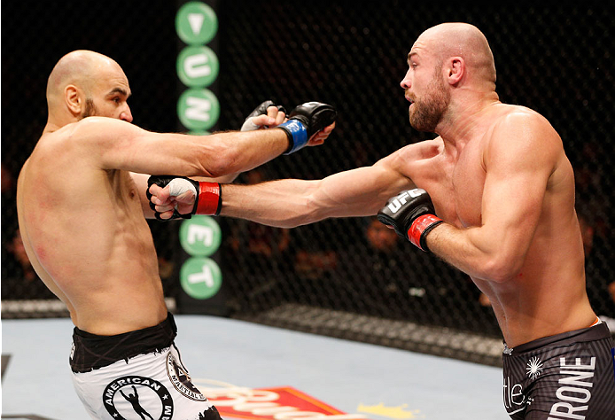 STOCKHOLM, SWEDEN - OCTOBER 04: (R-L) Cathal Pendred of Ireland punches Gasan Umalatov of Russia in their welterweight bout at the Ericsson Globe Arena on October 4, 2014 in Stockholm, Sweden. (Photo by Josh Hedges/Zuffa LLC/Zuffa LLC)