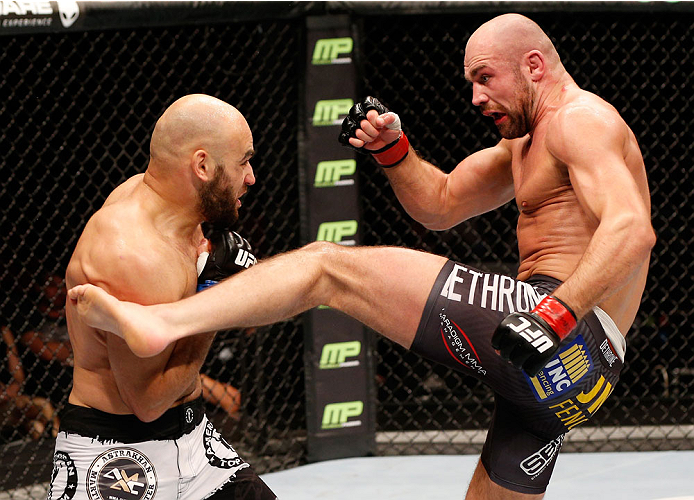 STOCKHOLM, SWEDEN - OCTOBER 04: (R-L) Cathal Pendred of Ireland kicks Gasan Umalatov of Russia in their welterweight bout at the Ericsson Globe Arena on October 4, 2014 in Stockholm, Sweden. (Photo by Josh Hedges/Zuffa LLC/Zuffa LLC)