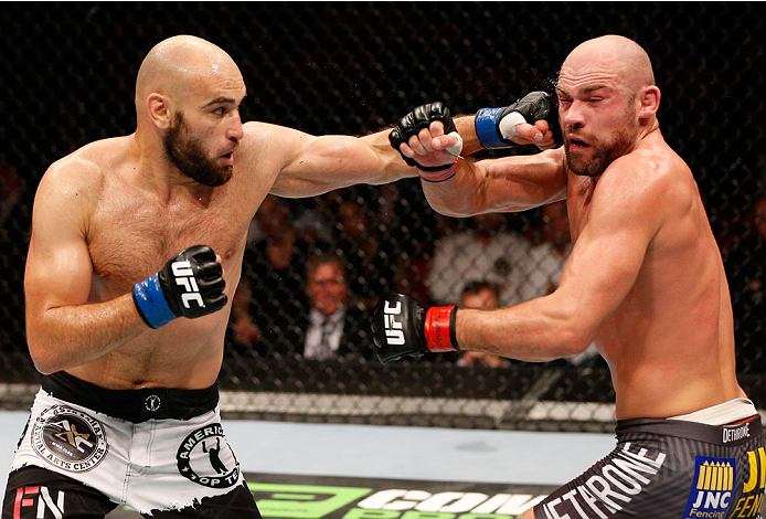 STOCKHOLM, SWEDEN - OCTOBER 04: (L-R) Gasan Umalatov of Russia punches Cathal Pendred of Ireland in their welterweight bout at the Ericsson Globe Arena on October 4, 2014 in Stockholm, Sweden. (Photo by Josh Hedges/Zuffa LLC/Zuffa LLC)