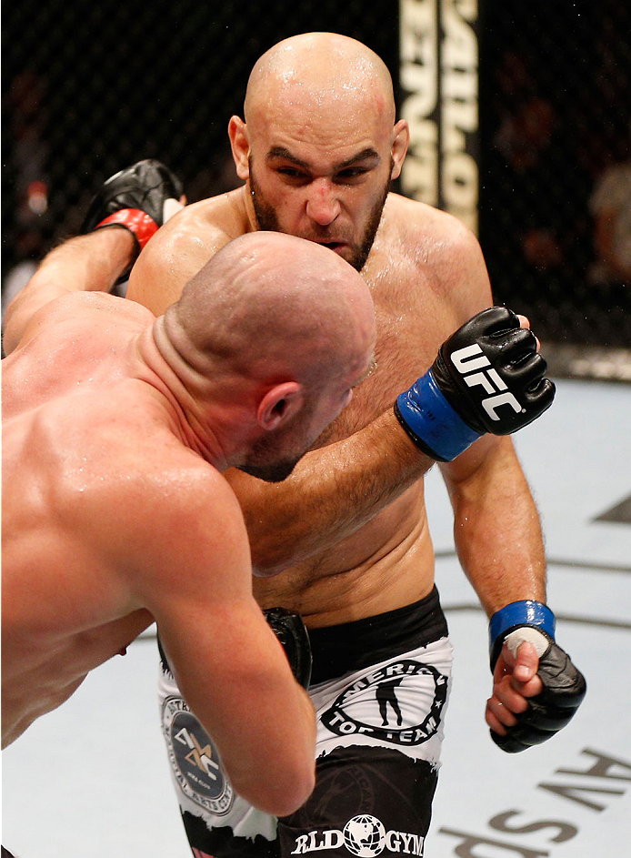 STOCKHOLM, SWEDEN - OCTOBER 04: (R-L) Gasan Umalatov of Russia punches Cathal Pendred of Ireland in their welterweight bout at the Ericsson Globe Arena on October 4, 2014 in Stockholm, Sweden. (Photo by Josh Hedges/Zuffa LLC/Zuffa LLC)