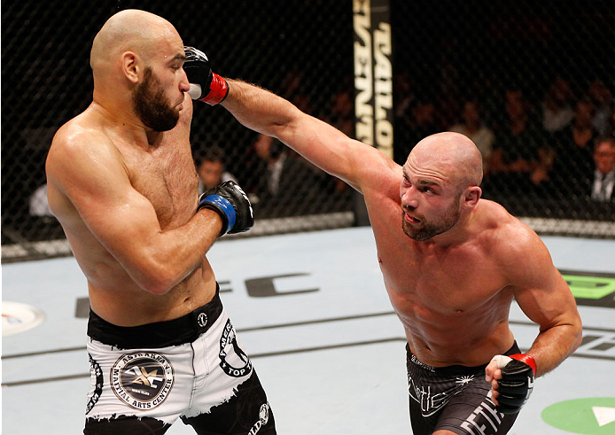 STOCKHOLM, SWEDEN - OCTOBER 04: (R-L) Cathal Pendred of Ireland punches Gasan Umalatov of Russia in their welterweight bout at the Ericsson Globe Arena on October 4, 2014 in Stockholm, Sweden. (Photo by Josh Hedges/Zuffa LLC/Zuffa LLC)
