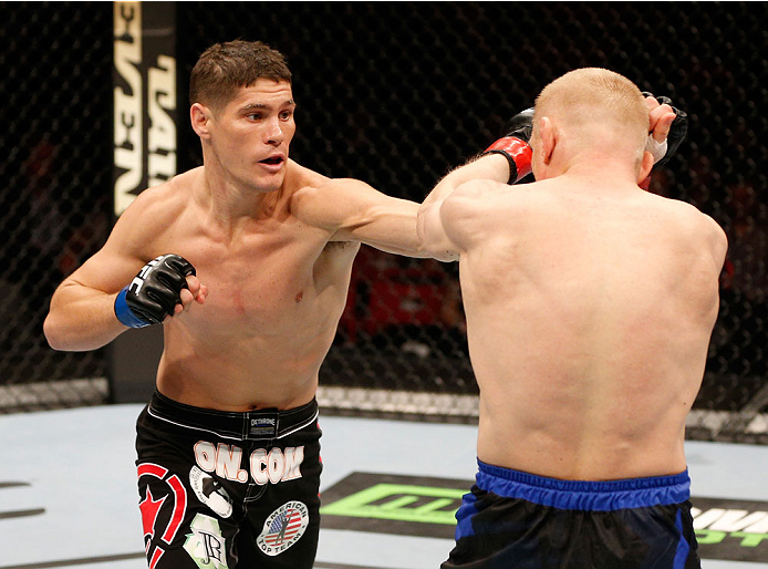STOCKHOLM, SWEDEN - OCTOBER 04: (L-R) Charles Rosa punches Dennis Siver of Germany in their featherweight bout at the Ericsson Globe Arena on October 4, 2014 in Stockholm, Sweden. (Photo by Josh Hedges/Zuffa LLC/Zuffa LLC)