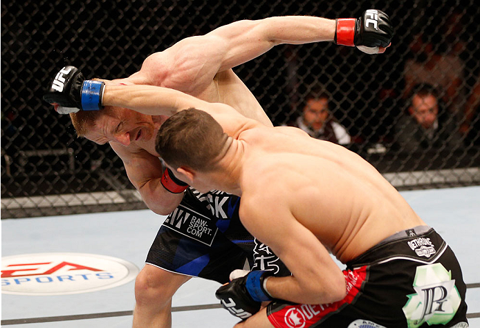 STOCKHOLM, SWEDEN - OCTOBER 04: (R-L) Charles Rosa punches Dennis Siver of Germany in their featherweight bout at the Ericsson Globe Arena on October 4, 2014 in Stockholm, Sweden. (Photo by Josh Hedges/Zuffa LLC/Zuffa LLC)