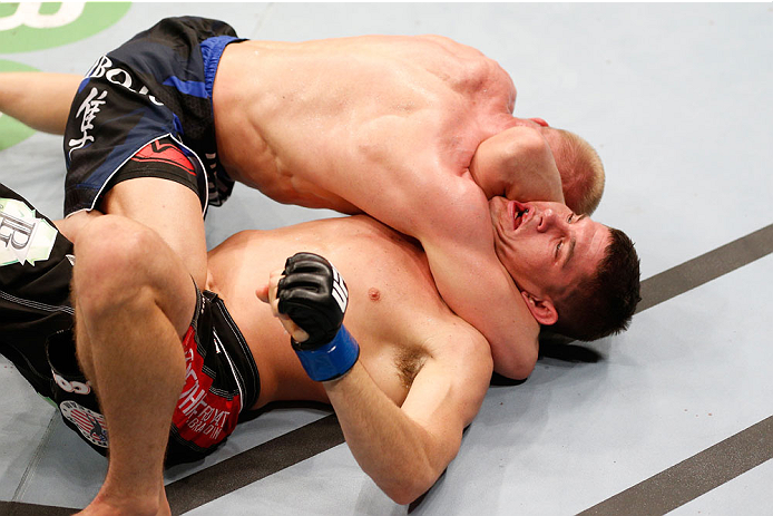 STOCKHOLM, SWEDEN - OCTOBER 04: (L-R) Dennis Siver of Germany attempts to secure an arm triangle choke submission against Charles Rosa in their featherweight bout at the Ericsson Globe Arena on October 4, 2014 in Stockholm, Sweden. (Photo by Josh Hedges