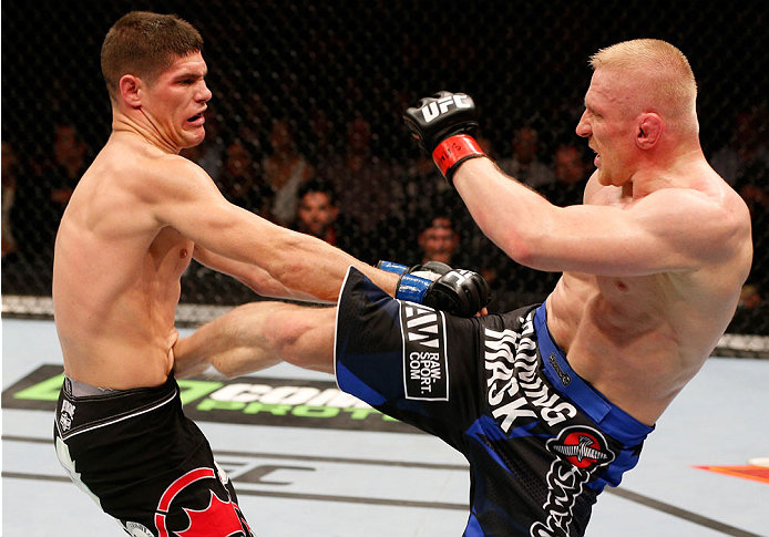 STOCKHOLM, SWEDEN - OCTOBER 04: (R-L) Dennis Siver of Germany kicks Charles Rosa in their featherweight bout at the Ericsson Globe Arena on October 4, 2014 in Stockholm, Sweden. (Photo by Josh Hedges/Zuffa LLC/Zuffa LLC)
