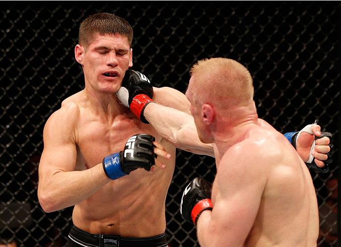 STOCKHOLM, SWEDEN - OCTOBER 04: (R-L) Dennis Siver of Germany punches Charles Rosa in their featherweight bout at the Ericsson Globe Arena on October 4, 2014 in Stockholm, Sweden. (Photo by Josh Hedges/Zuffa LLC/Zuffa LLC)