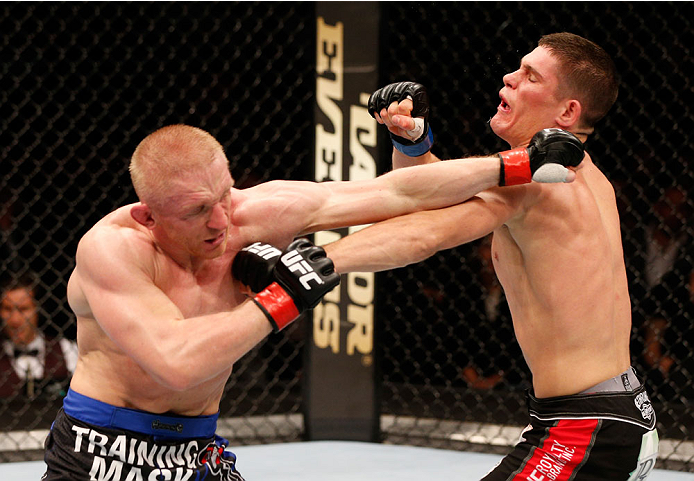 STOCKHOLM, SWEDEN - OCTOBER 04: (L-R) Dennis Siver of Germany punches Charles Rosa in their featherweight bout at the Ericsson Globe Arena on October 4, 2014 in Stockholm, Sweden. (Photo by Josh Hedges/Zuffa LLC/Zuffa LLC)
