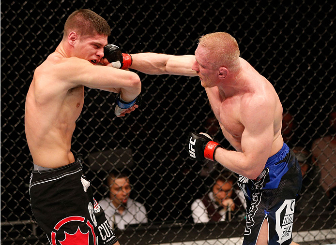 STOCKHOLM, SWEDEN - OCTOBER 04: (R-L) Dennis Siver of Germany punches Charles Rosa in their featherweight bout at the Ericsson Globe Arena on October 4, 2014 in Stockholm, Sweden. (Photo by Josh Hedges/Zuffa LLC/Zuffa LLC)