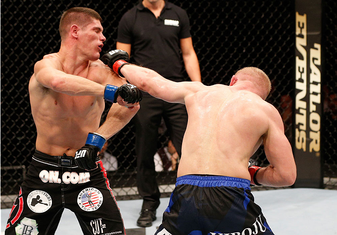 STOCKHOLM, SWEDEN - OCTOBER 04: (R-L) Dennis Siver of Germany punches Charles Rosa in their featherweight bout at the Ericsson Globe Arena on October 4, 2014 in Stockholm, Sweden. (Photo by Josh Hedges/Zuffa LLC/Zuffa LLC)