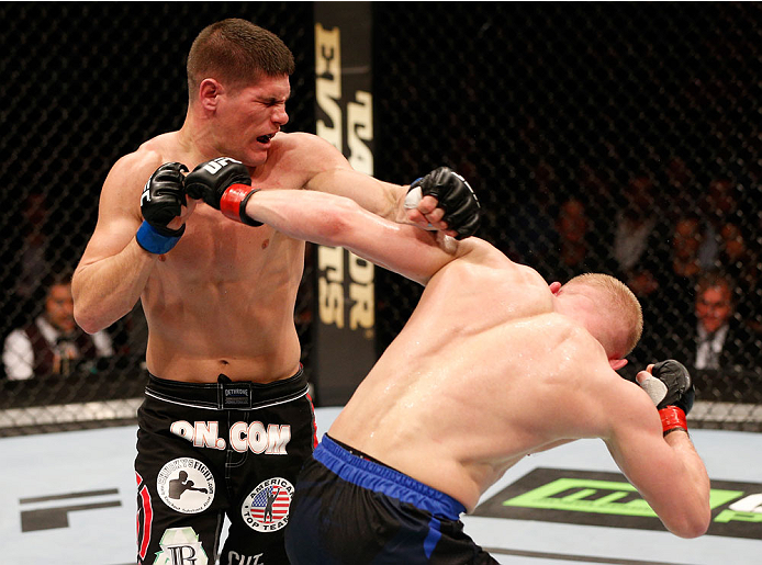STOCKHOLM, SWEDEN - OCTOBER 04: (R-L) Dennis Siver of Germany punches Charles Rosa in their featherweight bout at the Ericsson Globe Arena on October 4, 2014 in Stockholm, Sweden. (Photo by Josh Hedges/Zuffa LLC/Zuffa LLC)