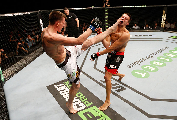 STOCKHOLM, SWEDEN - OCTOBER 04: (L-R) Scott Askham of England kicks Magnus Cedenblad of Sweden in their middleweight bout at the Ericsson Globe Arena on October 4, 2014 in Stockholm, Sweden. (Photo by Josh Hedges/Zuffa LLC/Zuffa LLC)