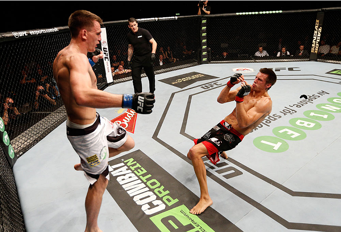 STOCKHOLM, SWEDEN - OCTOBER 04: (R-L) Magnus Cedenblad of Sweden falls to the canvas after a kick from Scott Askham of England in their middleweight bout at the Ericsson Globe Arena on October 4, 2014 in Stockholm, Sweden. (Photo by Josh Hedges/Zuffa LL