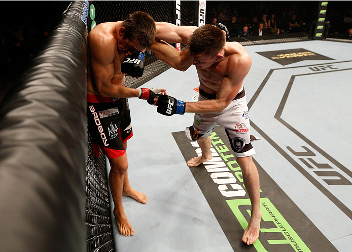 STOCKHOLM, SWEDEN - OCTOBER 04: (R-L) Scott Askham of England punches Magnus Cedenblad of Sweden in their middleweight bout at the Ericsson Globe Arena on October 4, 2014 in Stockholm, Sweden. (Photo by Josh Hedges/Zuffa LLC/Zuffa LLC)