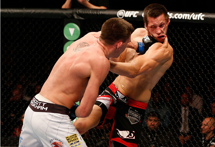 STOCKHOLM, SWEDEN - OCTOBER 04: (L-R) Scott Askham of England punches Magnus Cedenblad of Sweden in their middleweight bout at the Ericsson Globe Arena on October 4, 2014 in Stockholm, Sweden. (Photo by Josh Hedges/Zuffa LLC/Zuffa LLC)