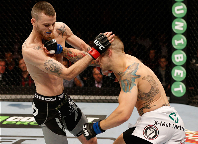 STOCKHOLM, SWEDEN - OCTOBER 04: (R-L) Mike Wilkinson of England punches Niklas Backstrom of Sweden in their featherweight bout at the Ericsson Globe Arena on October 4, 2014 in Stockholm, Sweden. (Photo by Josh Hedges/Zuffa LLC/Zuffa LLC)