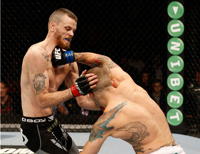STOCKHOLM, SWEDEN - OCTOBER 04: (R-L) Mike Wilkinson of England punches Niklas Backstrom of Sweden in their featherweight bout at the Ericsson Globe Arena on October 4, 2014 in Stockholm, Sweden. (Photo by Josh Hedges/Zuffa LLC/Zuffa LLC)