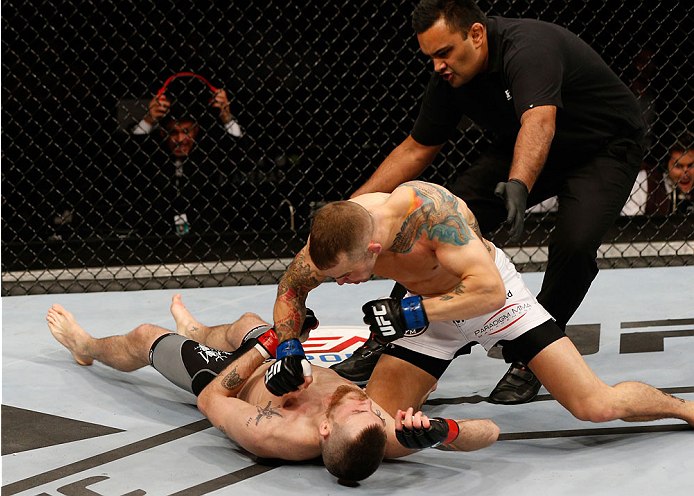 STOCKHOLM, SWEDEN - OCTOBER 04: (R-L) Mike Wilkinson of England knocks out Niklas Backstrom of Sweden with a series of punches in their featherweight bout at the Ericsson Globe Arena on October 4, 2014 in Stockholm, Sweden. (Photo by Josh Hedges/Zuffa L