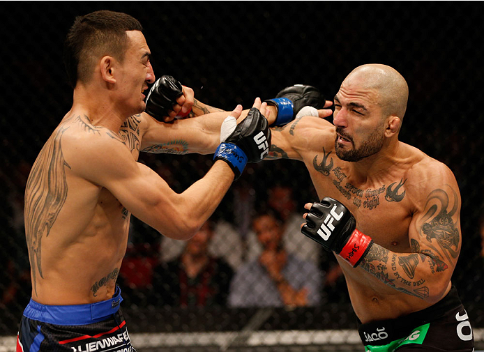 STOCKHOLM, SWEDEN - OCTOBER 04: (R-L) Akira Corassani of Sweden punches Max Holloway in their featherweight bout at the Ericsson Globe Arena on October 4, 2014 in Stockholm, Sweden. (Photo by Josh Hedges/Zuffa LLC/Zuffa LLC)