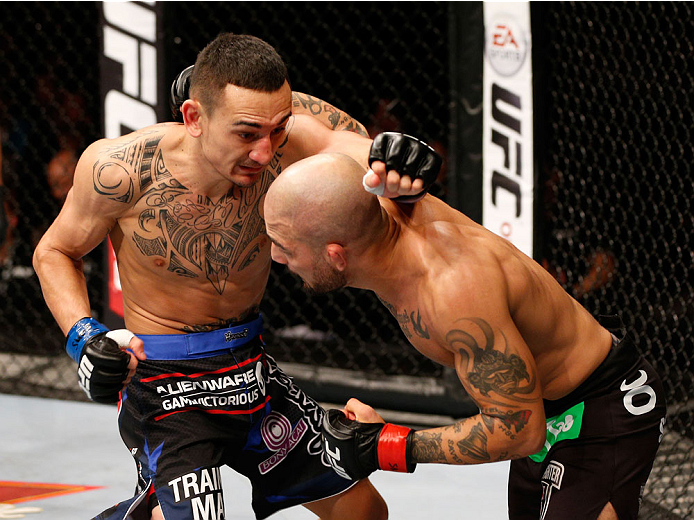 STOCKHOLM, SWEDEN - OCTOBER 04: (L-R) Max Holloway punches Akira Corassani of Sweden in their featherweight bout at the Ericsson Globe Arena on October 4, 2014 in Stockholm, Sweden. (Photo by Josh Hedges/Zuffa LLC/Zuffa LLC)