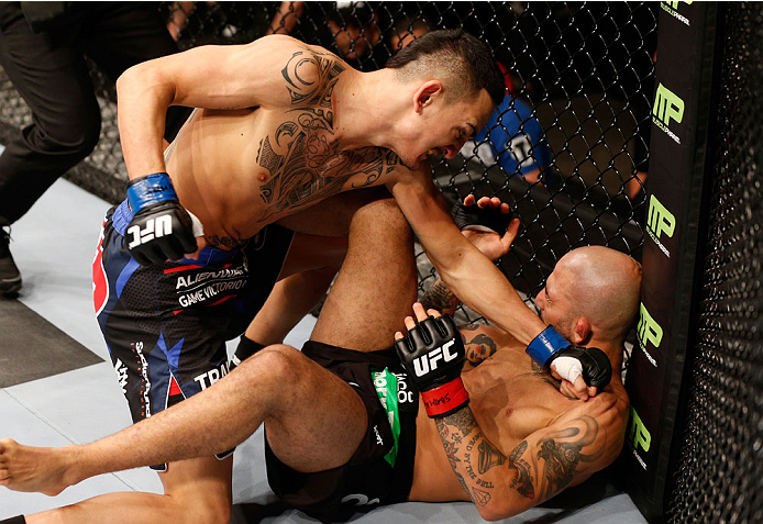 STOCKHOLM, SWEDEN - OCTOBER 04: (L-R) Max Holloway punches Akira Corassani of Sweden in their featherweight bout at the Ericsson Globe Arena on October 4, 2014 in Stockholm, Sweden. (Photo by Josh Hedges/Zuffa LLC/Zuffa LLC)