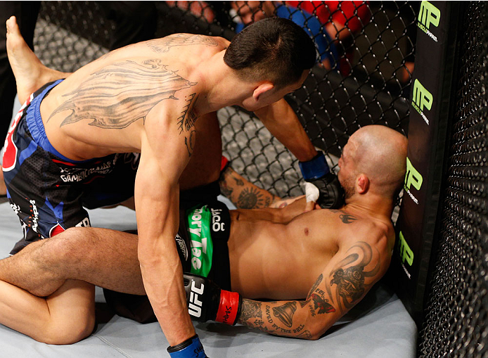 STOCKHOLM, SWEDEN - OCTOBER 04: (L-R) Max Holloway punches Akira Corassani of Sweden in their featherweight bout at the Ericsson Globe Arena on October 4, 2014 in Stockholm, Sweden. (Photo by Josh Hedges/Zuffa LLC/Zuffa LLC)