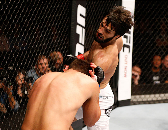 STOCKHOLM, SWEDEN - OCTOBER 04: (R-L) Zubaira Tukhugov of Russia punches Ernest Chavez in their featherweight bout at the Ericsson Globe Arena on October 4, 2014 in Stockholm, Sweden. (Photo by Josh Hedges/Zuffa LLC/Zuffa LLC)