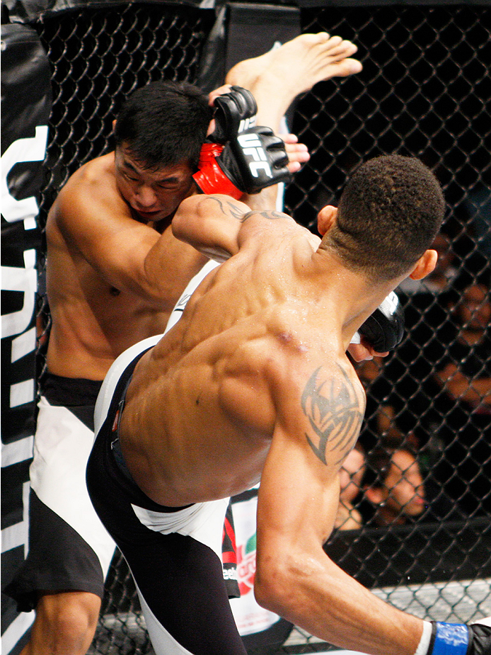SAITAMA, JAPAN - SEPTEMBER 27: Kajan Johnson of Canada goes for a kick on Naoyuki Kotani of Japan in their lightweight bout during the UFC event at the Saitama Super Arena on September 27, 2015 in Saitama, Japan. (Photo by Mitch Viquez/Zuffa LLC/Zuffa LL