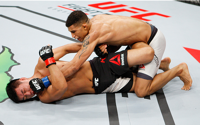 SAITAMA, JAPAN - SEPTEMBER 27: Kajan Johnson of Canada punches Naoyuki Kotani of Japan in their lightweight bout during the UFC event at the Saitama Super Arena on September 27, 2015 in Saitama, Japan. (Photo by Mitch Viquez/Zuffa LLC/Zuffa LLC via Getty