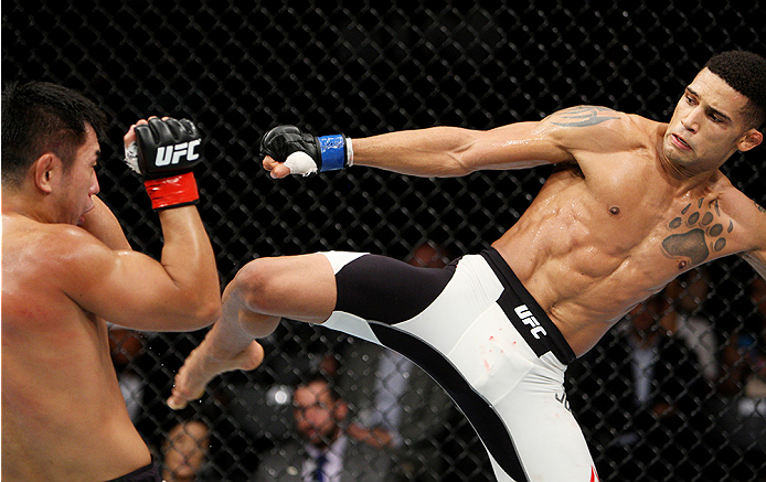 SAITAMA, JAPAN - SEPTEMBER 27: Kajan Johnson of Canada goes fora kick on Naoyuki Kotani of Japan in their lightweight bout during the UFC event at the Saitama Super Arena on September 27, 2015 in Saitama, Japan. (Photo by Mitch Viquez/Zuffa LLC/Zuffa LLC