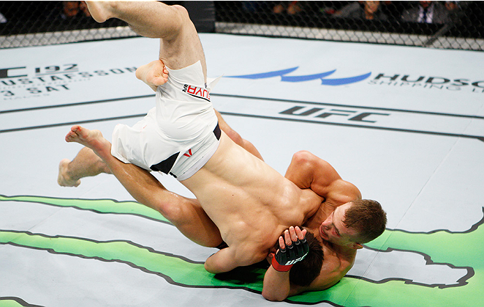 SAITAMA, JAPAN - SEPTEMBER 27: (From L to R) Yusuke Kasuya of Japan and Nick Hein of Germany scramble for a takedown in their lightweight bout during the UFC event at the Saitama Super Arena on September 27, 2015 in Saitama, Japan. (Photo by Mitch Vique