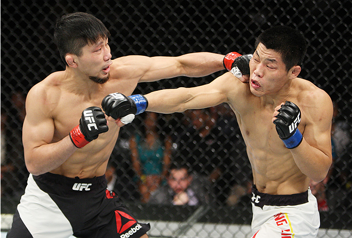 SAITAMA, JAPAN - SEPTEMBER 27: Keita Nakamura of Japan punches Li Jingliang of China in their welterweight bout during the UFC event at the Saitama Super Arena on September 27, 2015 in Saitama, Japan. (Photo by Mitch Viquez/Zuffa LLC/Zuffa LLC via Getty I