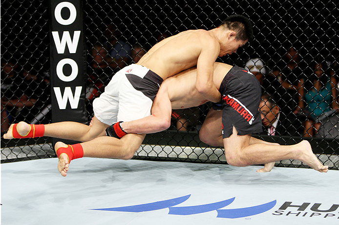 SAITAMA, JAPAN - SEPTEMBER 27: Keita Nakamura of Japan shoots for a takedown on Li Jingliang of China in their welterweight bout during the UFC event at the Saitama Super Arena on September 27, 2015 in Saitama, Japan. (Photo by Mitch Viquez/Zuffa LLC/Zuf