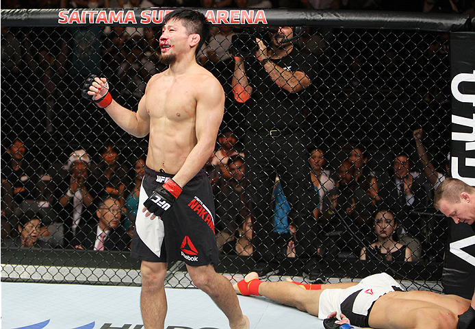 SAITAMA, JAPAN - SEPTEMBER 27: Keita Nakamura of Japan celebrates his win over an unconscious Li Jingliang of China in their welterweight bout during the UFC event at the Saitama Super Arena on September 27, 2015 in Saitama, Japan. (Photo by Mitch Viquez