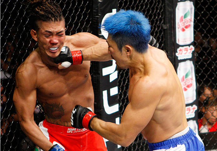 SAITAMA, JAPAN - SEPTEMBER 27: (From L to R) Teruto Ishihara of Japan and Mizuto Hirota of Japan exchange punches in their featherweight bout during the UFC event at the Saitama Super Arena on September 27, 2015 in Saitama, Japan. (Photo by Mitch Viquez/Z