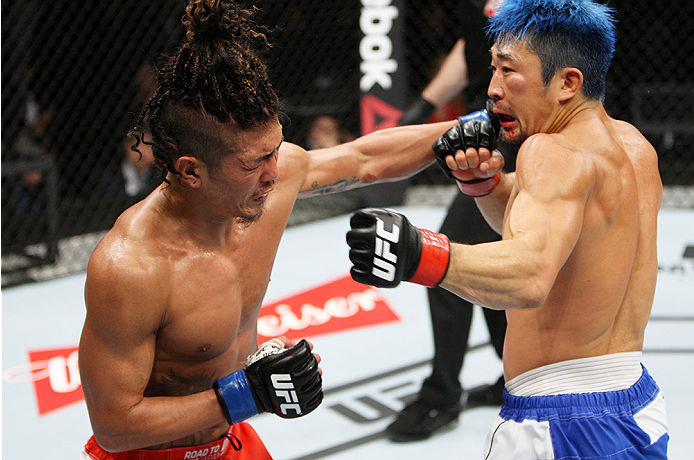 SAITAMA, JAPAN - SEPTEMBER 27: (From L to R) Teruto Ishihara of Japan and Mizuto Hirota of Japan exchange punches in their featherweight bout during the UFC event at the Saitama Super Arena on September 27, 2015 in Saitama, Japan. (Photo by Mitch Viquez/