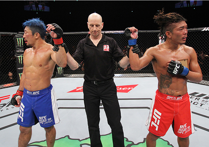 SAITAMA, JAPAN - SEPTEMBER 27: (From L to R) Mizuto Hirota of Japan and Teruto Ishihara of Japan react after hearing their featherweight bout was a majority draw during the UFC event at the Saitama Super Arena on September 27, 2015 in Saitama, Japan. (Ph