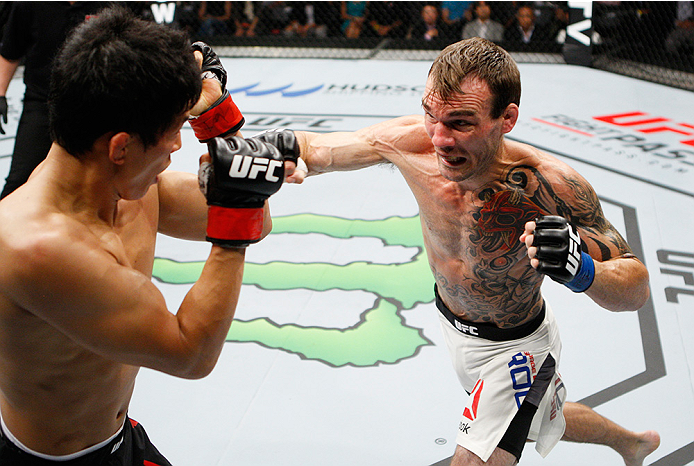SAITAMA, JAPAN - SEPTEMBER 27: George Roop of the United States of America throws a punch at Takeya Mizugaki of Japan in their bantamweight bout during the UFC event at the Saitama Super Arena on September 27, 2015 in Saitama, Japan. (Photo by Mitch Vique