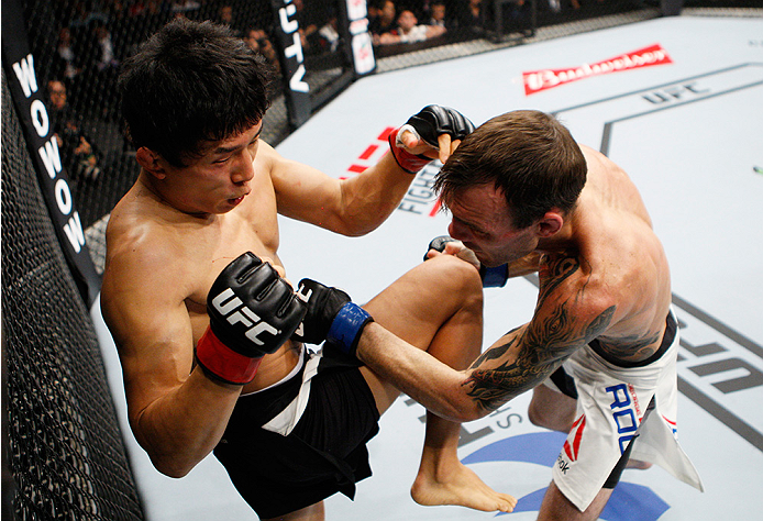 SAITAMA, JAPAN - SEPTEMBER 27: Takeya Mizugaki of Japan throws a knee on George Roop of the United States of America in their bantamweight bout during the UFC event at the Saitama Super Arena on September 27, 2015 in Saitama, Japan. (Photo by Mitch Vique