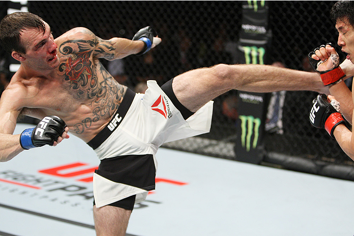 SAITAMA, JAPAN - SEPTEMBER 27: George Roop of the United States of America kicks Takeya Mizugaki of Japan in their bantamweight bout during the UFC event at the Saitama Super Arena on September 27, 2015 in Saitama, Japan. (Photo by Mitch Viquez/Zuffa LLC/