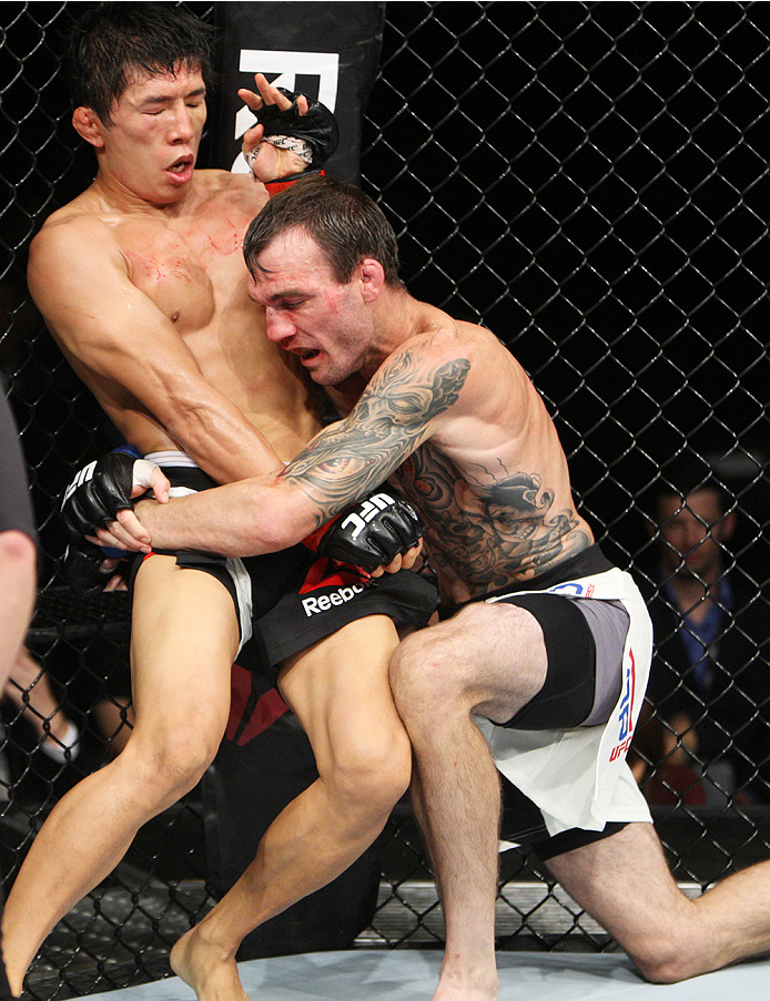 SAITAMA, JAPAN - SEPTEMBER 27: George Roop of the United States of America goes for a takedown on Takeya Mizugaki of Japan in their bantamweight bout during the UFC event at the Saitama Super Arena on September 27, 2015 in Saitama, Japan. (Photo by Mitch