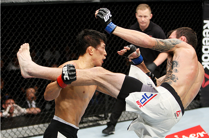 SAITAMA, JAPAN - SEPTEMBER 27: Takeya Mizugaki of Japan goes for a takedown on George Roop of the United States of America in their bantamweight bout during the UFC event at the Saitama Super Arena on September 27, 2015 in Saitama, Japan. (Photo by Mitch