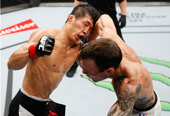 SAITAMA, JAPAN - SEPTEMBER 27: George Roop of the United States of America throws an elbow at Takeya Mizugaki of Japan in their bantamweight bout during the UFC event at the Saitama Super Arena on September 27, 2015 in Saitama, Japan. (Photo by Mitch Viqu