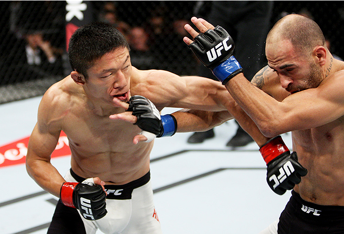 SAITAMA, JAPAN - SEPTEMBER 27: (From L to R) Kyoji Horiguchi of Japan and Chico Camus of the United States of America exchange punches in their flyweight bout during the UFC event at the Saitama Super Arena on September 27, 2015 in Saitama, Japan. (Photo