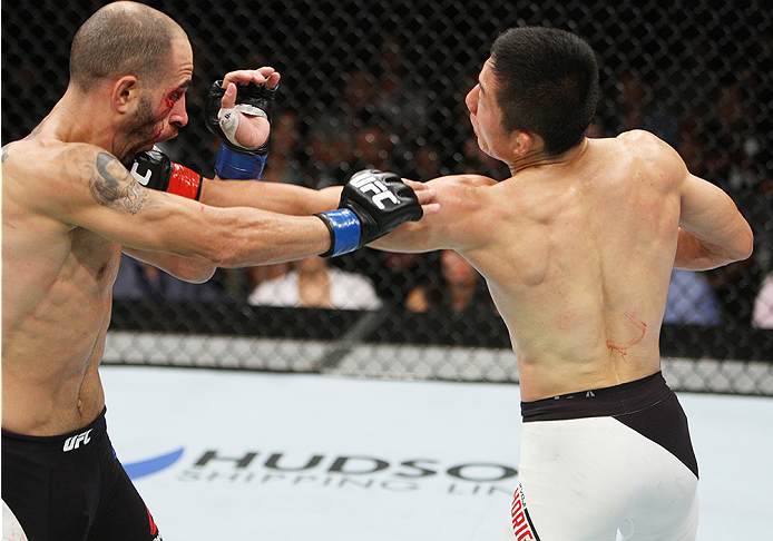SAITAMA, JAPAN - SEPTEMBER 27: Kyoji Horiguchi of Japan punches Chico Camus of the United States of America in their flyweight bout during the UFC event at the Saitama Super Arena on September 27, 2015 in Saitama, Japan. (Photo by Mitch Viquez/Zuffa LLC/Z
